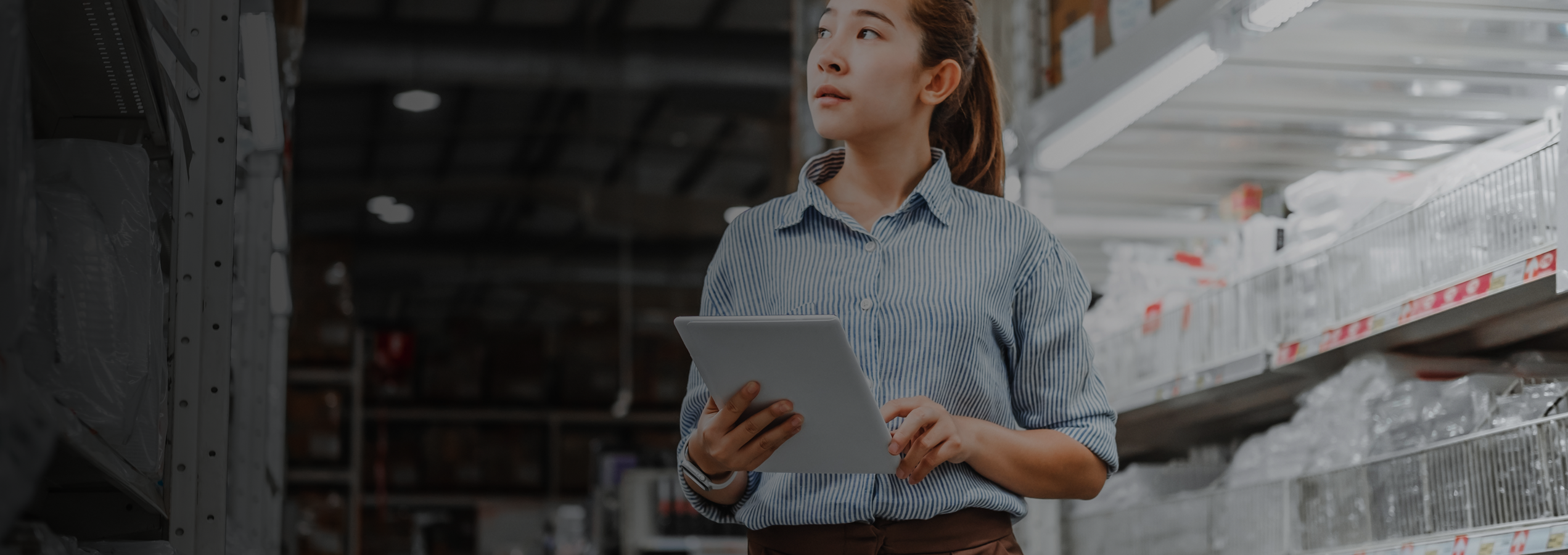 Woman Walking Thru Aisles With Ipad